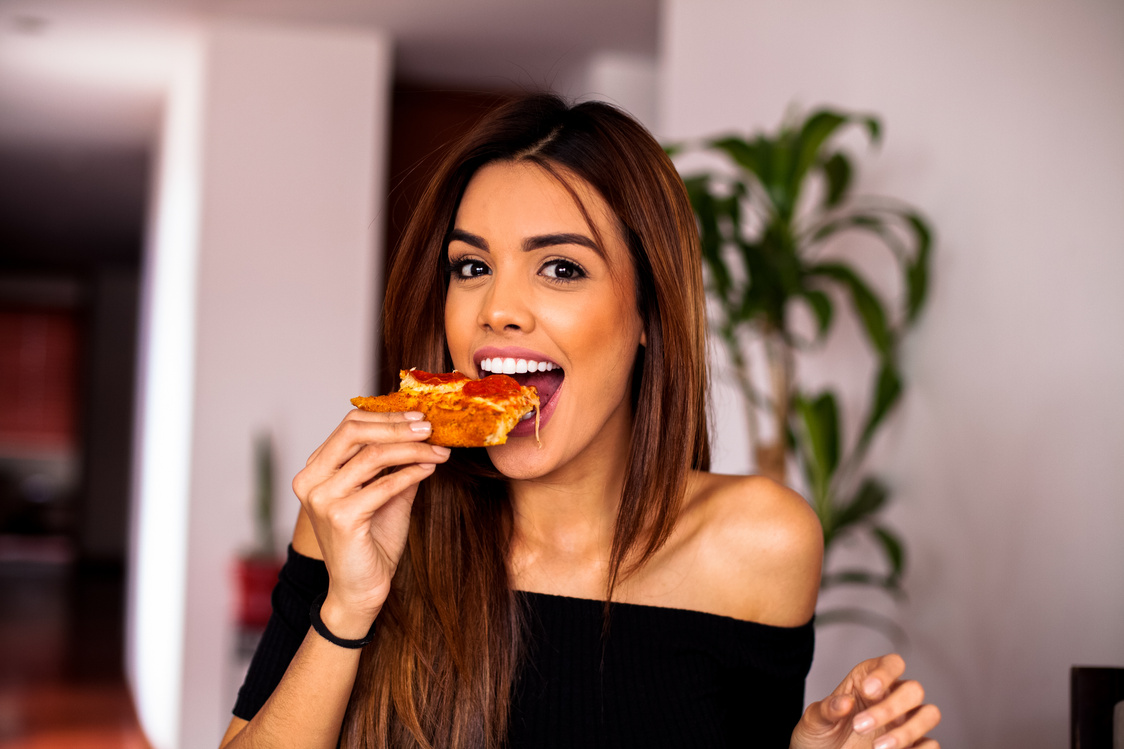 Woman eating a pizza